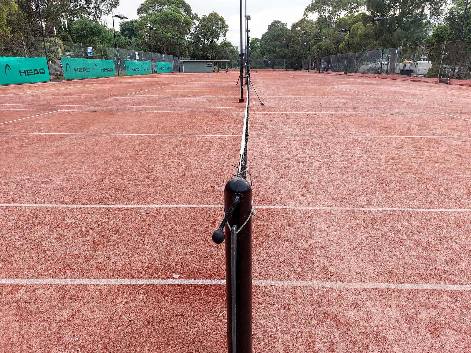 Clay tennis court viewed down the net